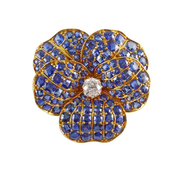 Late 19th / early 20th century sapphire and diamond cluster pansy brooch, 1900, centred by a cushion cut diamond of approximately 1.50ct, each petal pave set with cushion cut sapphires,